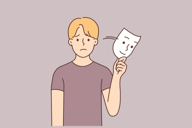 摄图网_381081443_不开心的男人摘下微笑面具_(企业商用).jpg